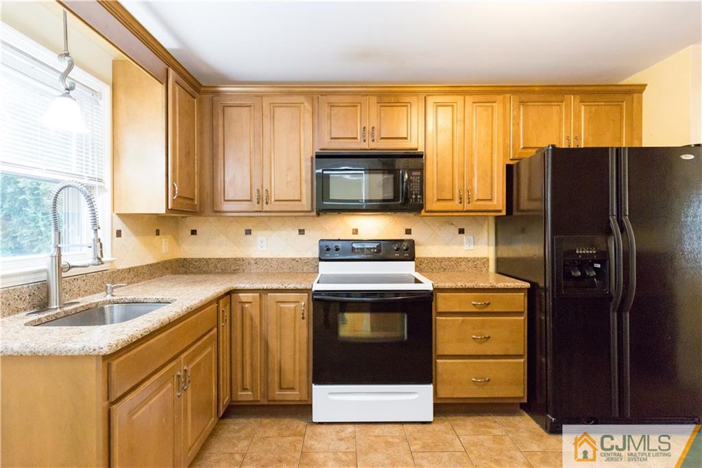169 Old Post Road Edison, NJ 08817 - Photo 12 of 36 a kitchen with stainless steel appliances granite countertop a stove a refrigerator and a sink