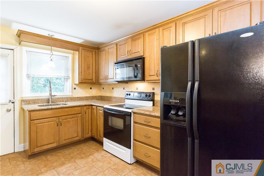 169 Old Post Road Edison, NJ 08817 - Photo 13 of 36 a kitchen with stainless steel appliances granite countertop a refrigerator and a sink