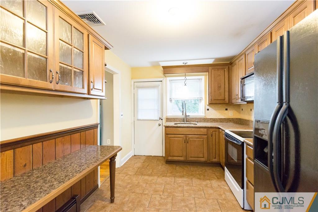 169 Old Post Road Edison, NJ 08817 - Photo 14 of 36 a kitchen with stainless steel appliances granite countertop a stove and a refrigerator