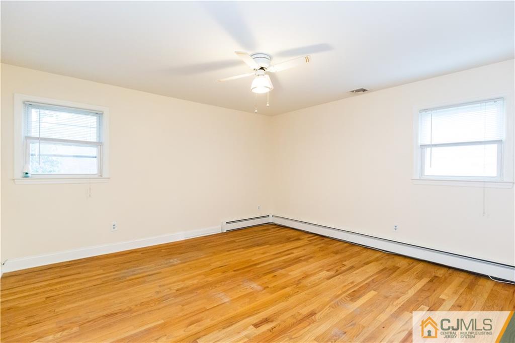169 Old Post Road Edison, NJ 08817 - Photo 15 of 36 an empty room with a window and a ceiling fan