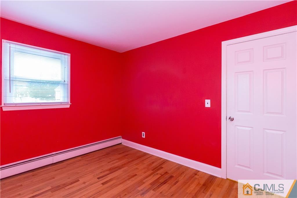 169 Old Post Road Edison, NJ 08817 - Photo 20 of 36 a view of empty room with wooden floor and fan