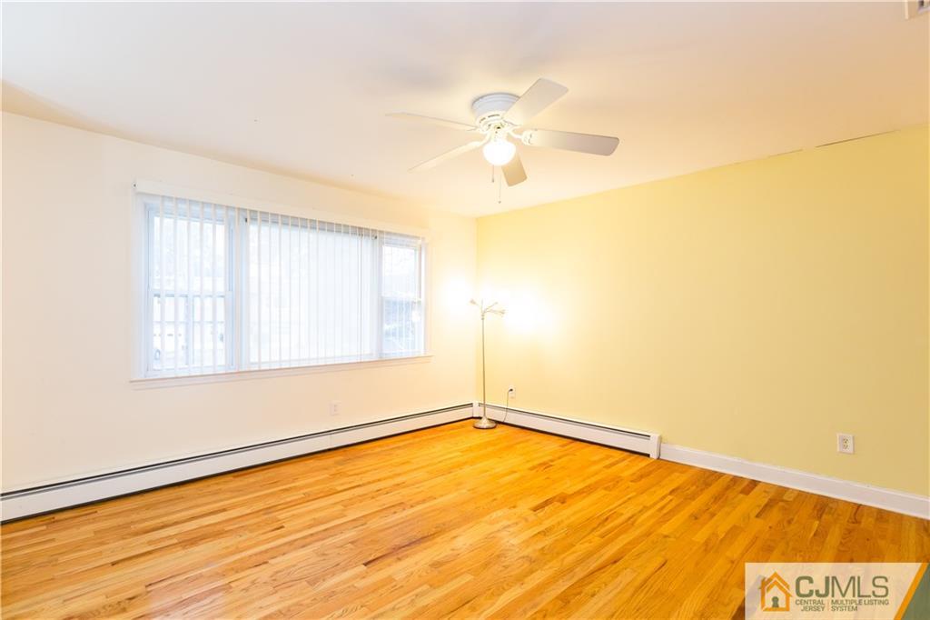 169 Old Post Road Edison, NJ 08817 - Photo 3 of 36 a view of empty room with wooden floor and fan