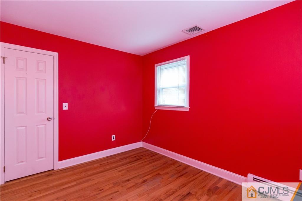 169 Old Post Road Edison, NJ 08817 - Photo 22 of 36 a view of empty room with wooden floor and red wall