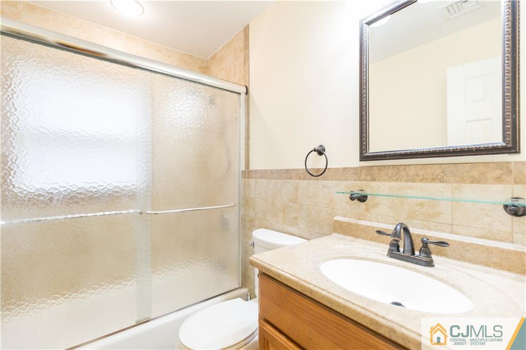 169 Old Post Road Edison, NJ 08817 - Photo 23 of 36 a bathroom with a sink and a mirror