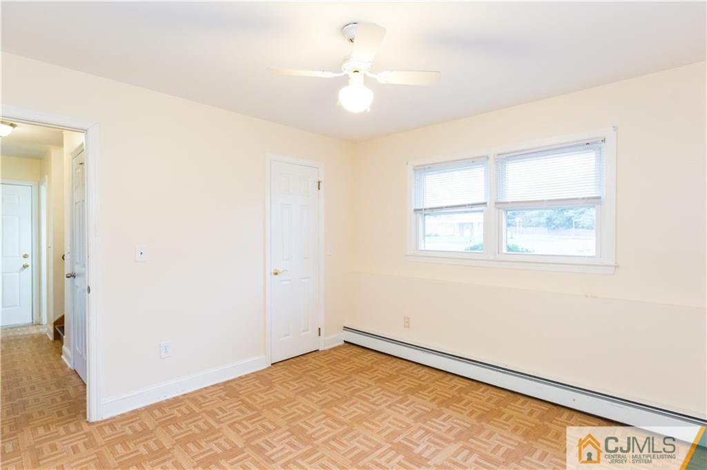 169 Old Post Road Edison, NJ 08817 - Photo 27 of 36 an empty room with a window and a ceiling fan