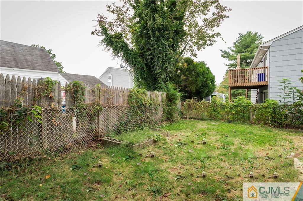 169 Old Post Road Edison, NJ 08817 - Photo 32 of 36 a view of a house with a yard and potted plants