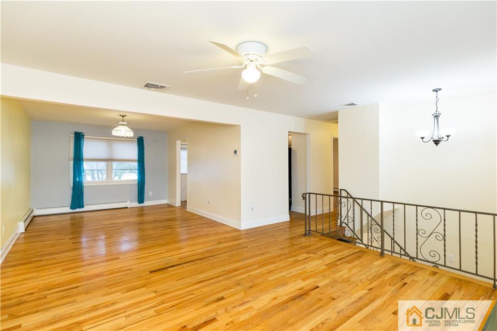 169 Old Post Road Edison, NJ 08817 - Photo 5 of 36 a view of a bedroom with wooden floor and a ceiling fan