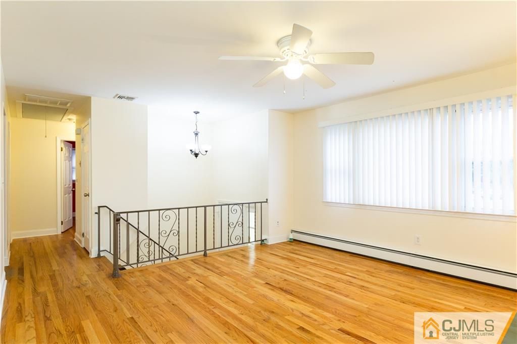 169 Old Post Road Edison, NJ 08817 - Photo 6 of 36 a view of a room with wooden floor and fan