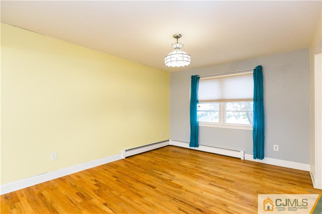 169 Old Post Road Edison, NJ 08817 - Photo 8 of 36 a view of empty room with wooden floor and window
