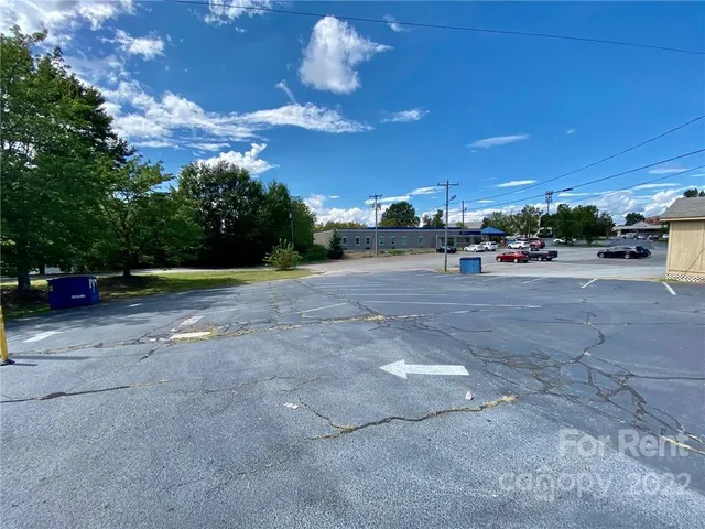 a view of a patio with a table and chairs under an umbrella