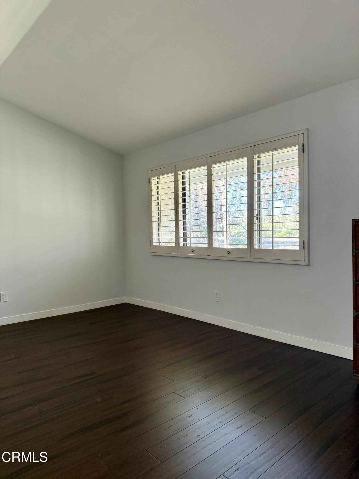 1213 Calle Lozano Camarillo, CA 93012 - Photo 14 of 29 a view of an empty room with wooden floor and a window