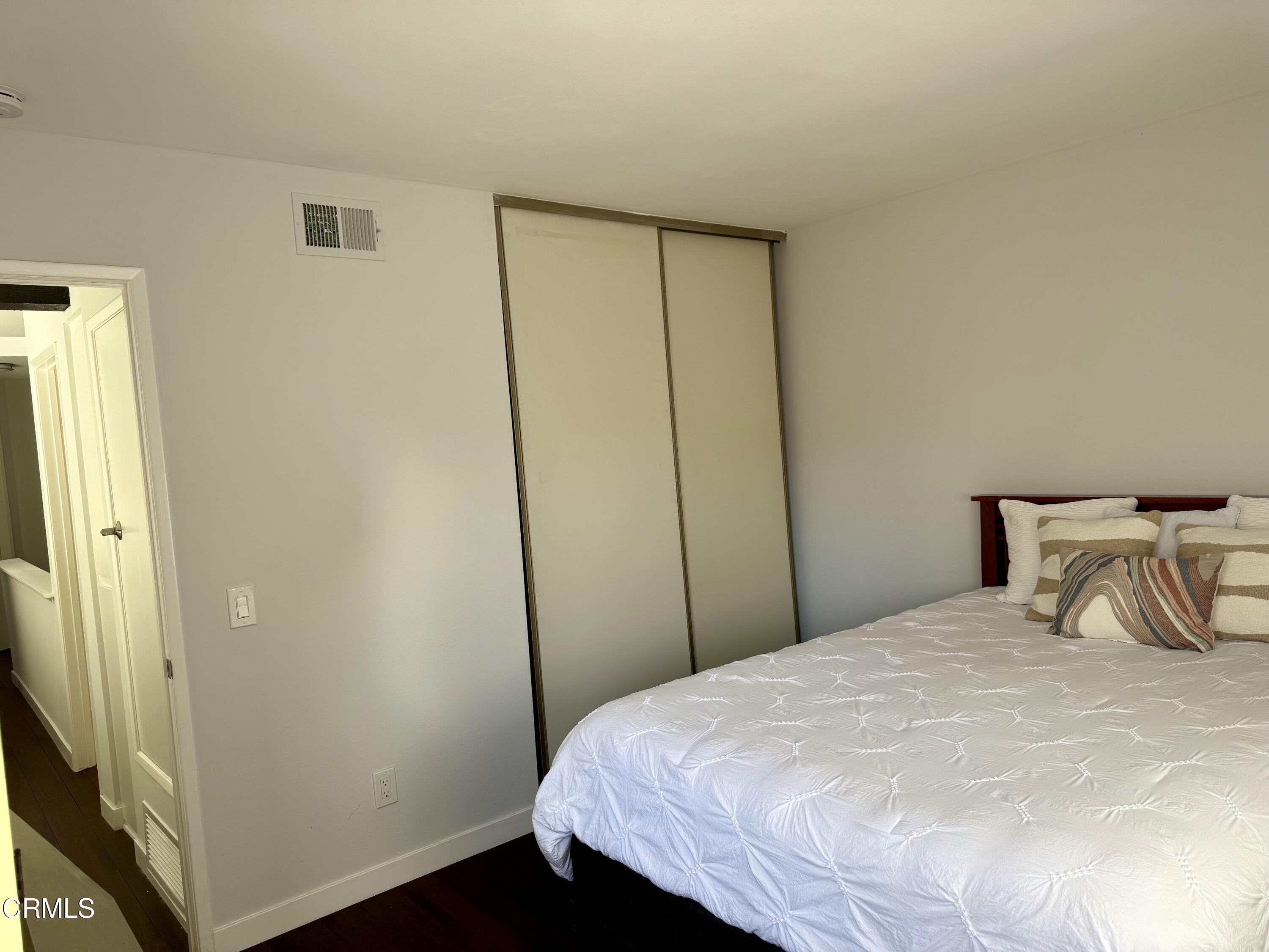 1213 Calle Lozano Camarillo, CA 93012 - Photo 20 of 29 a bedroom with a bed and a mirror