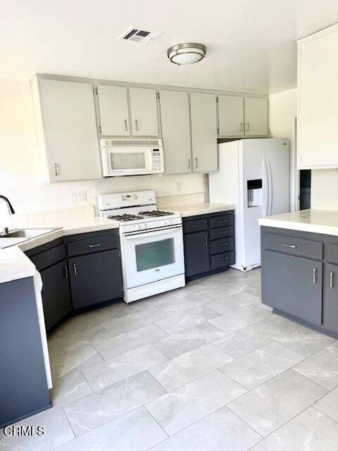 1213 Calle Lozano Camarillo, CA 93012 - Photo 9 of 29 a large kitchen with stainless steel appliances granite countertop a stove sink and cabinets