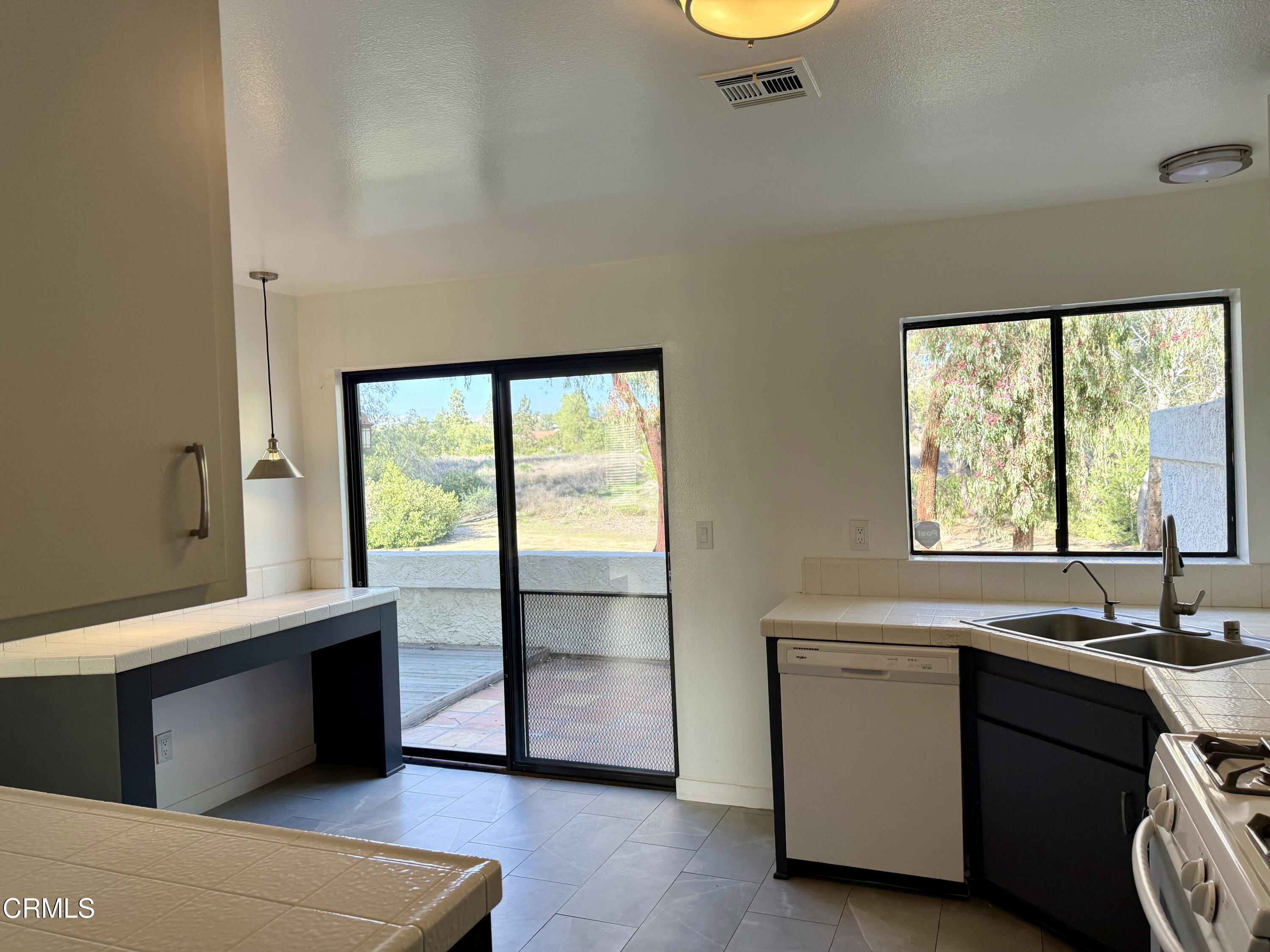 1213 Calle Lozano Camarillo, CA 93012 - Photo 10 of 29 a view of a kitchen with a sink cabinet and a window