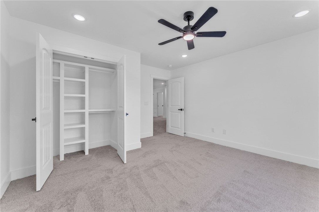 1723 Harris Bridge Road Anderson, SC 29621 - Photo 23 of 33 A well-lit bedroom features plush carpeting and a convenient, organized closet.