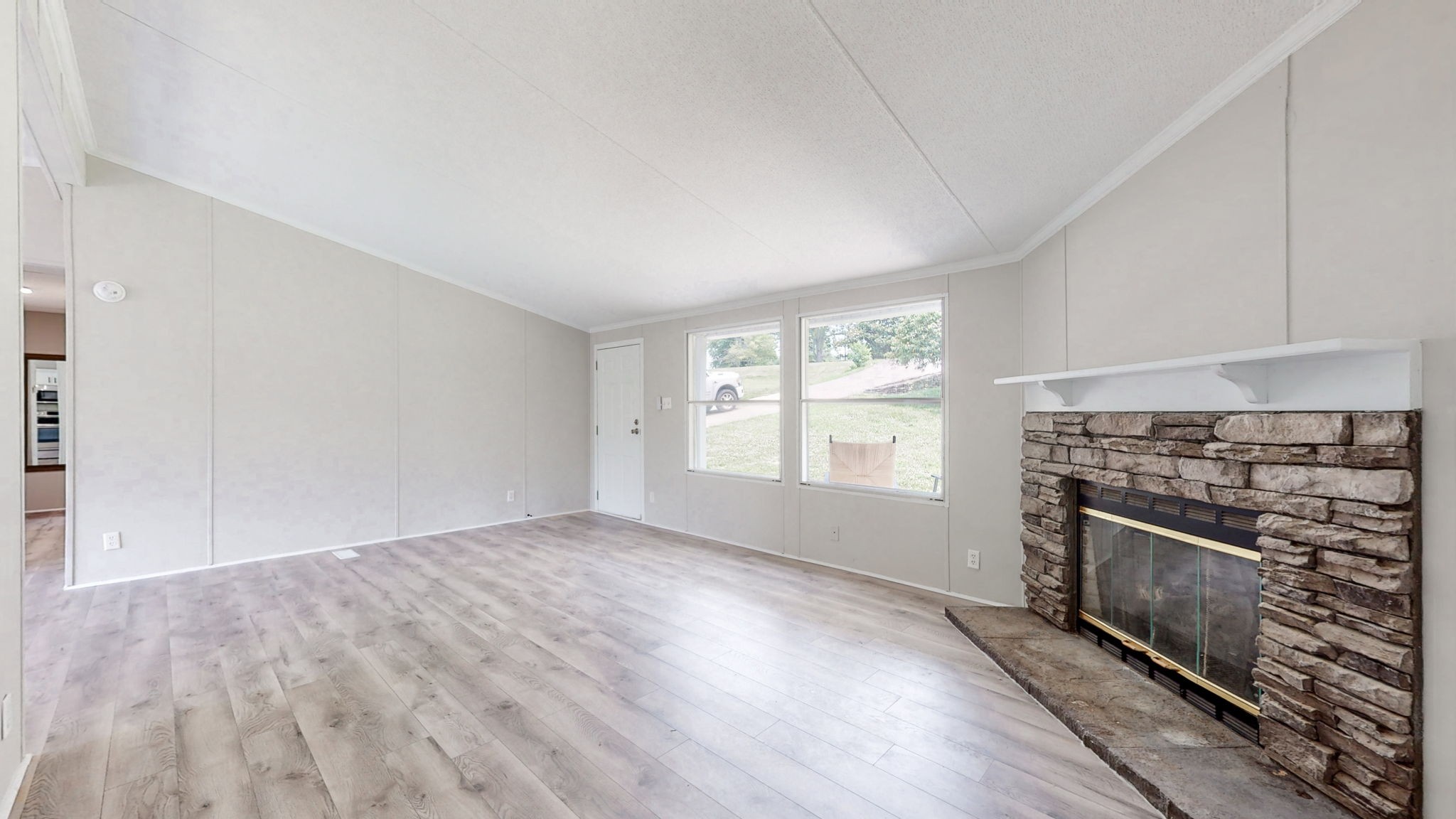 5023 Benders Ferry Road Mount Juliet, TN 37122 - Photo 13 of 62 an empty room with windows fireplace and wooden floor