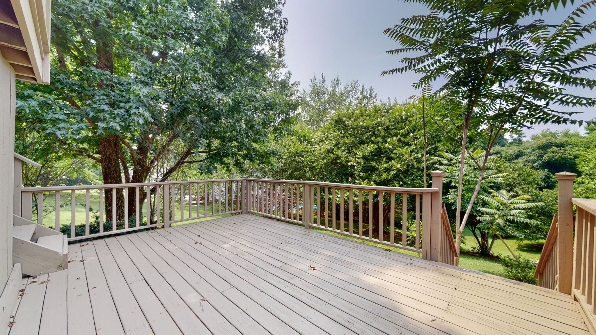 5023 Benders Ferry Road Mount Juliet, TN 37122 - Photo 47 of 62 a balcony with wooden floor and trees in the back