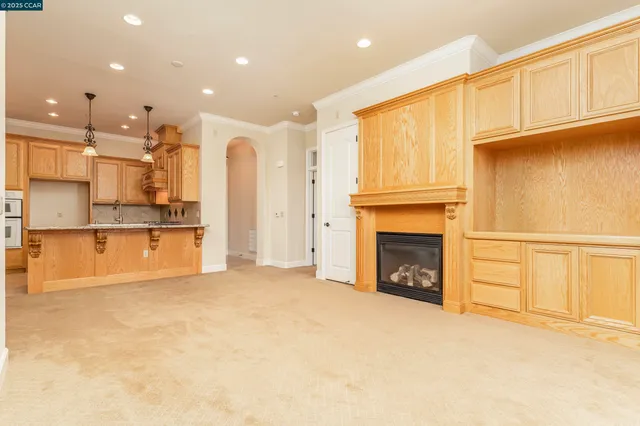 a kitchen with a table chairs refrigerator and cabinets