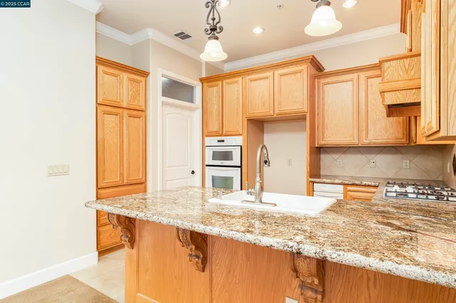 a kitchen with a sink stove and cabinets