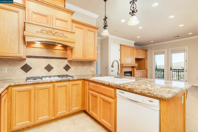 a kitchen with granite countertop cabinets and wooden floor