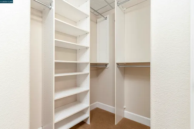 a bedroom with beds and a window