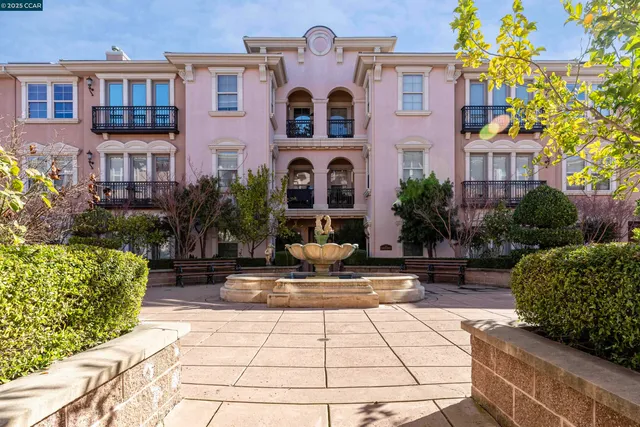 a view of a livingroom with a fireplace a chandelier and wooden floor