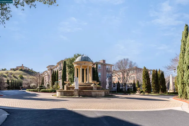 a living room with furniture a fireplace and a chandelier
