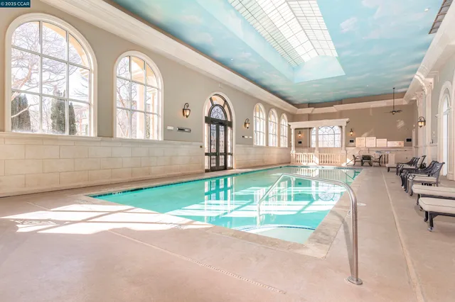 a view of a swimming pool with outdoor seating