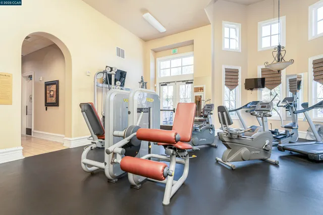 a view of a big room with wooden floor and a kitchen