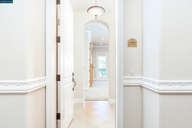a view of an empty room with a fireplace and a window