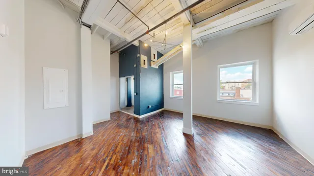 a view of a room with wooden floor and a window