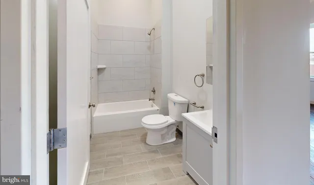 a bathroom with a toilet a sink and bathtub