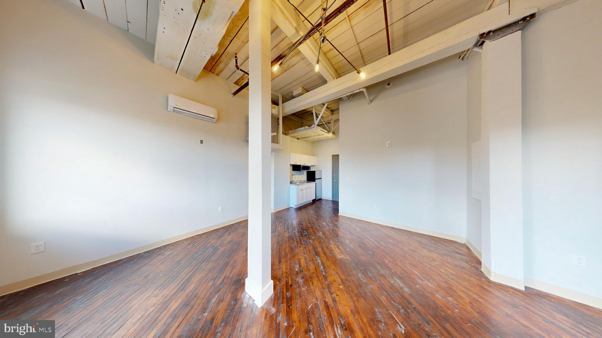 100 South 4th Street, Unit 202 Reading, PA 19602 - Photo 7 of 15 a view of a hallway with wooden floor and staircase
