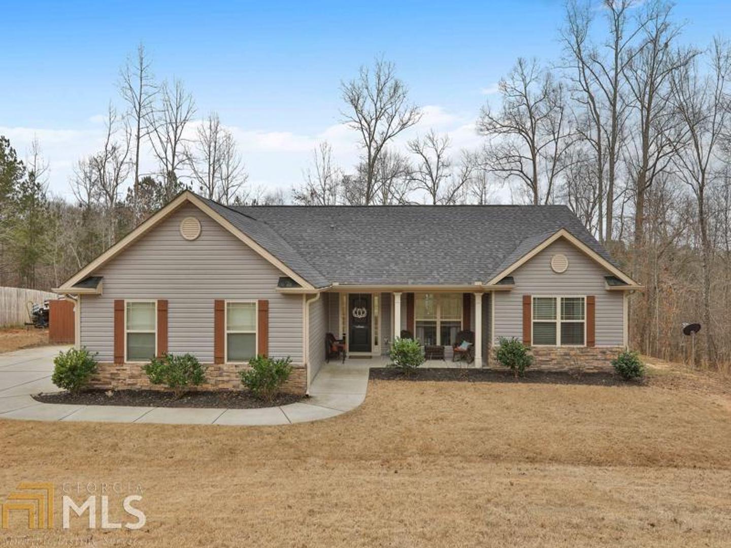 84 Coggins Road Newnan, GA 30263 - Photo 1 of 1 a front view of a house with a yard and garage