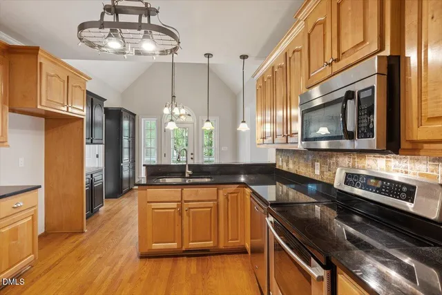 a kitchen with stainless steel appliances a stove sink and cabinets