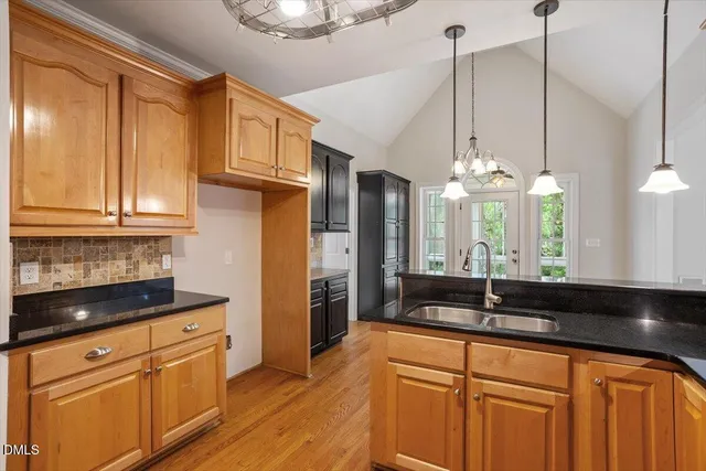 a kitchen with stainless steel appliances granite countertop a sink a counter space and cabinets