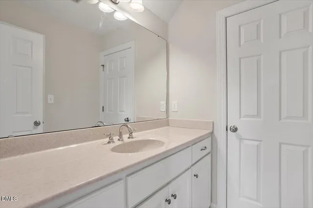 a bathroom with 2 sink and a mirror