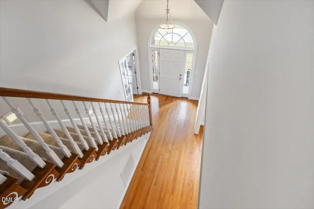 a view of an empty room with a fireplace and a window