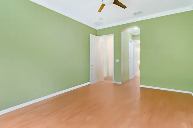 a view of a big room with wooden floor and windows