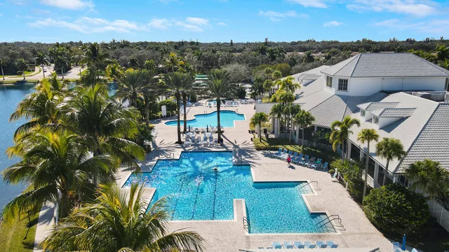 an aerial view of residential houses with outdoor space and ocean view