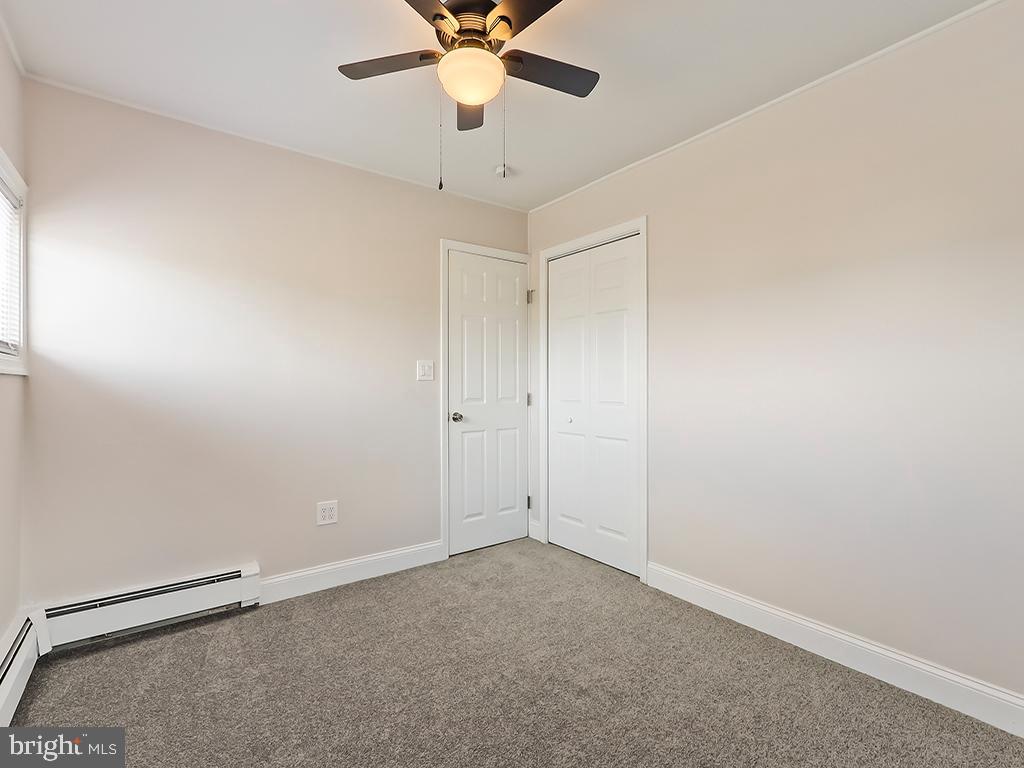 10 Blue Ridge Drive Levittown, PA 19057 - Photo 21 of 31 an empty room with a window and a fan