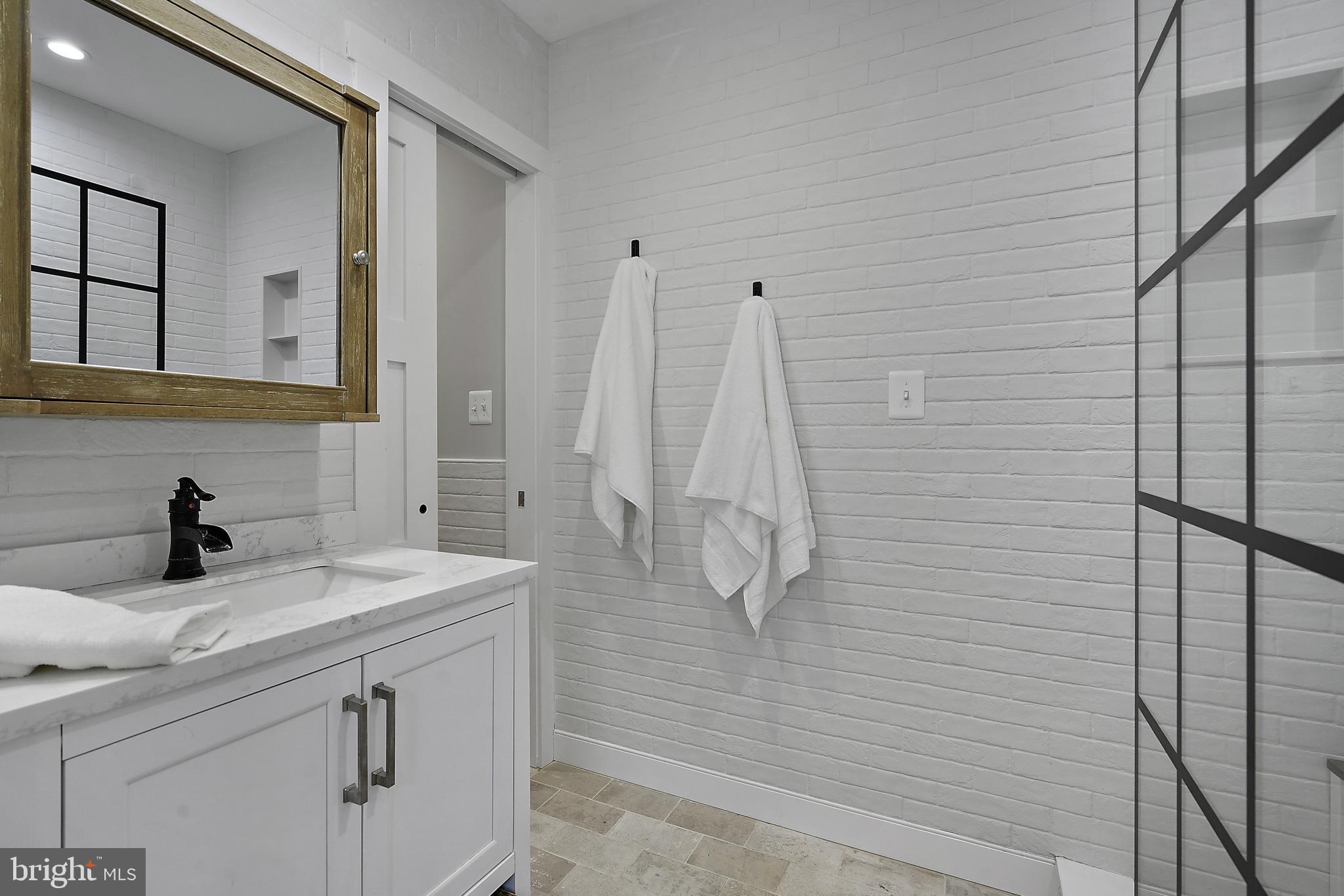 39913 Thomas Mill Road Leesburg, VA 20175 - Photo 11 of 46 a bathroom with a sink vanity and shower