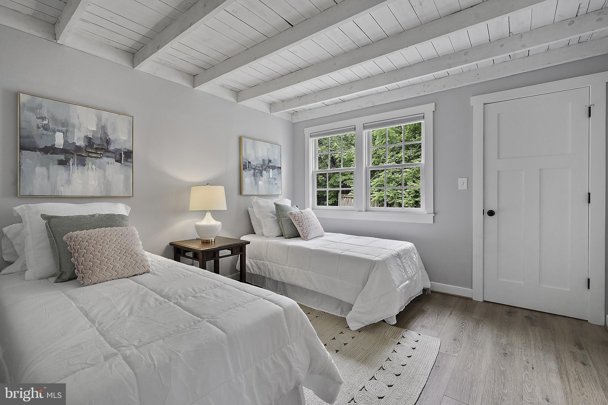 39913 Thomas Mill Road Leesburg, VA 20175 - Photo 12 of 46 a bedroom with two beds and a painting on the wall