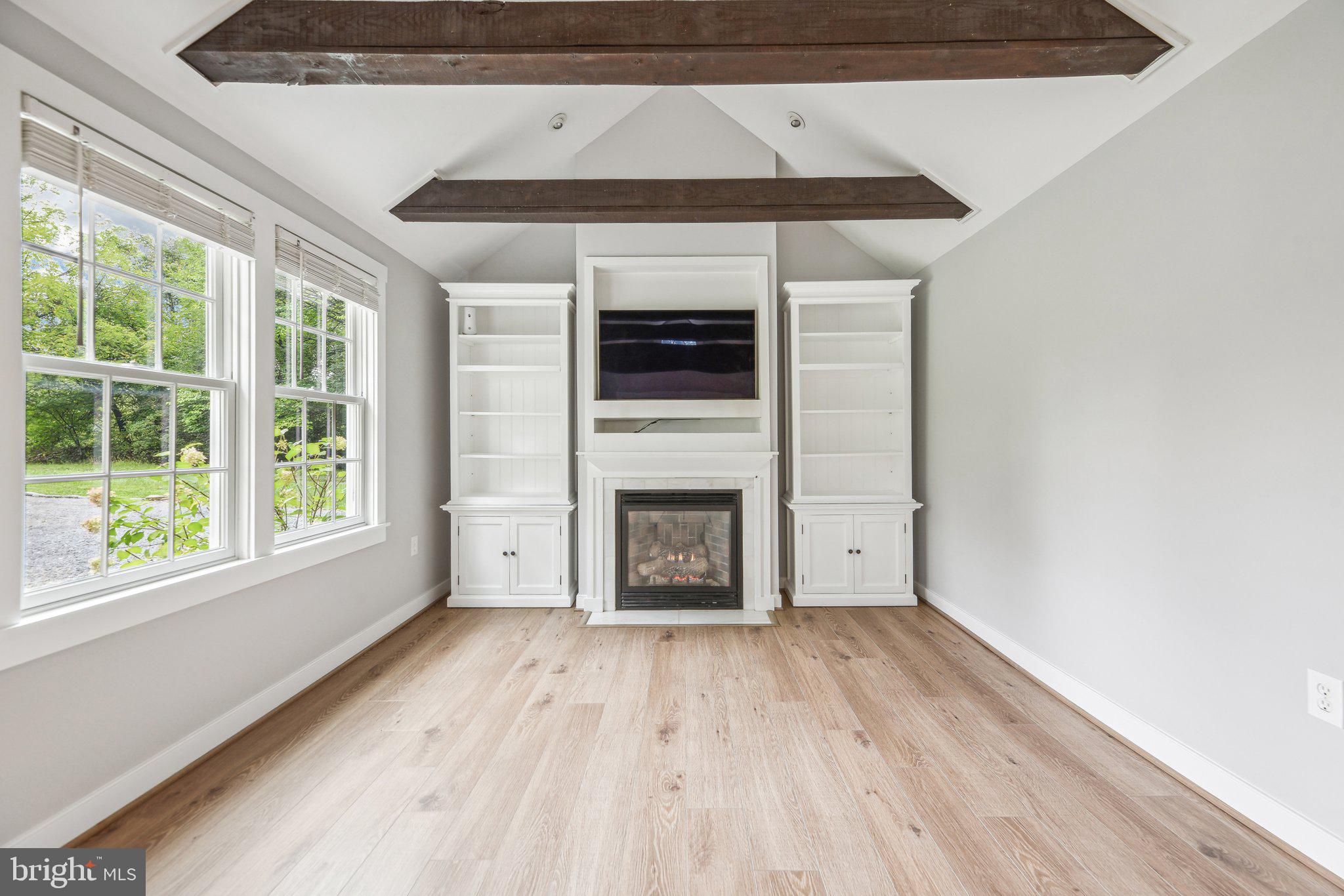 39913 Thomas Mill Road Leesburg, VA 20175 - Photo 17 of 46 a view of empty room with wooden floor and fireplace