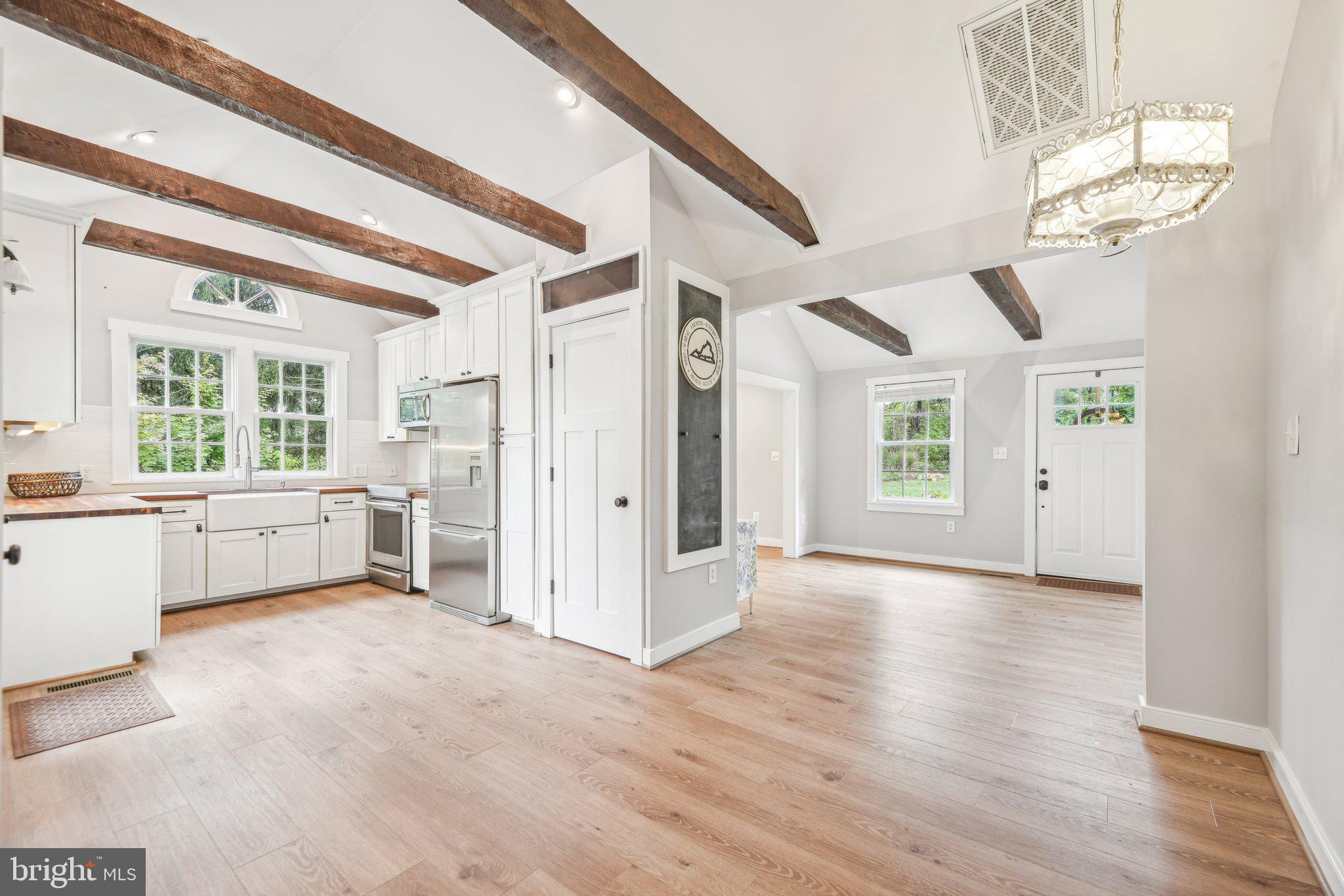 39913 Thomas Mill Road Leesburg, VA 20175 - Photo 21 of 46 a view of a big room with wooden floor and windows