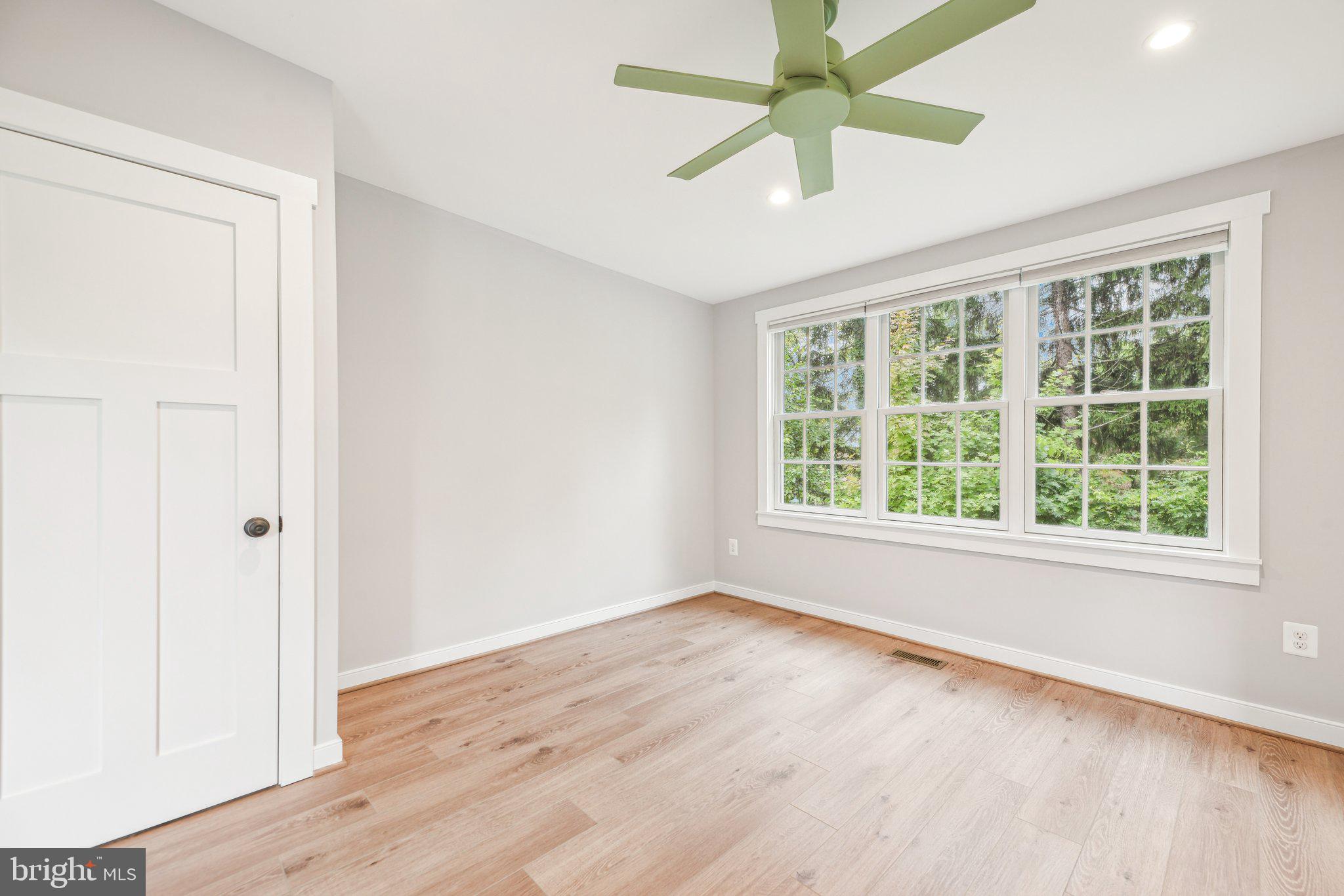 39913 Thomas Mill Road Leesburg, VA 20175 - Photo 26 of 46 an empty room with wooden floor fan and windows