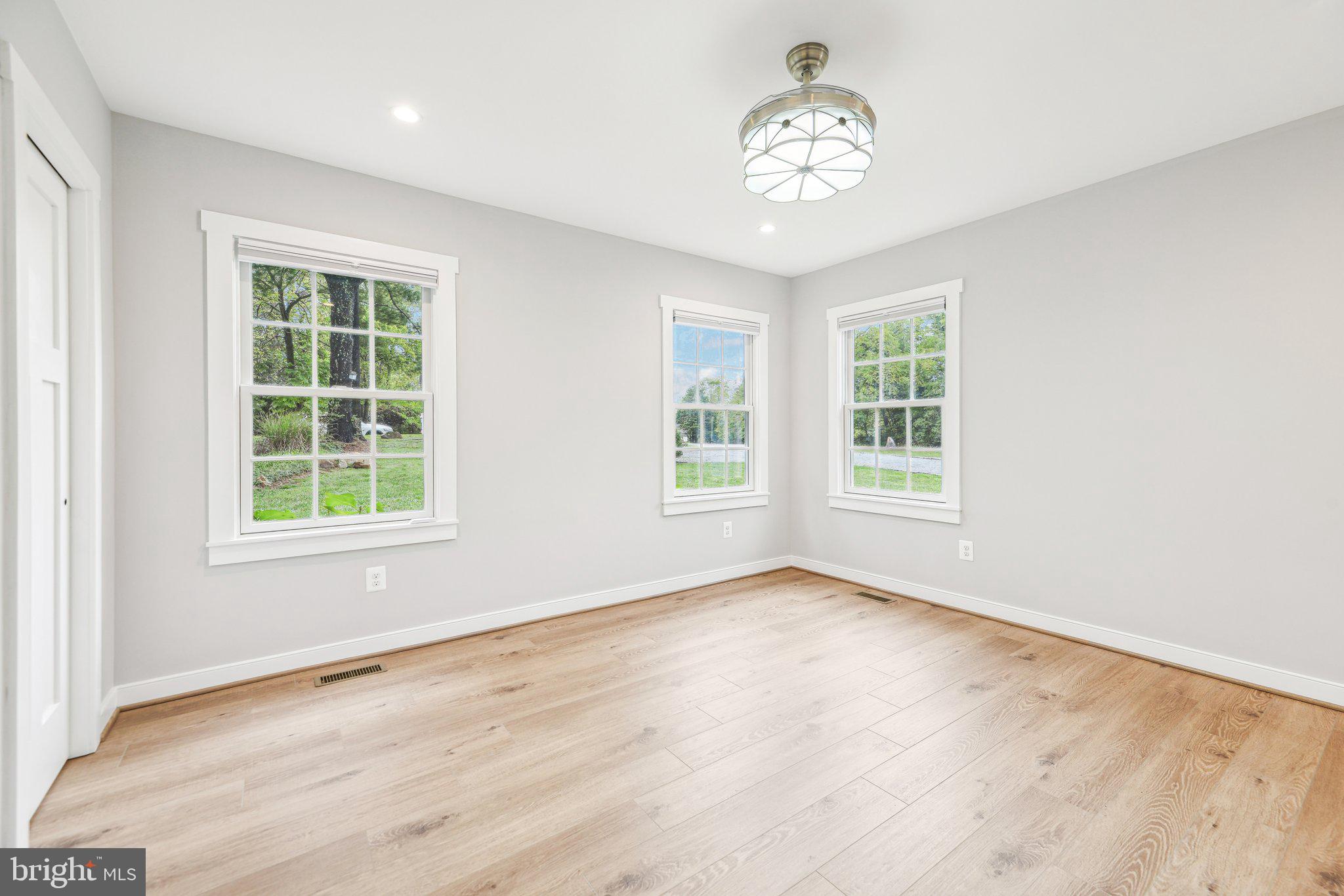 39913 Thomas Mill Road Leesburg, VA 20175 - Photo 30 of 46 a view of an empty room with wooden floor and a window