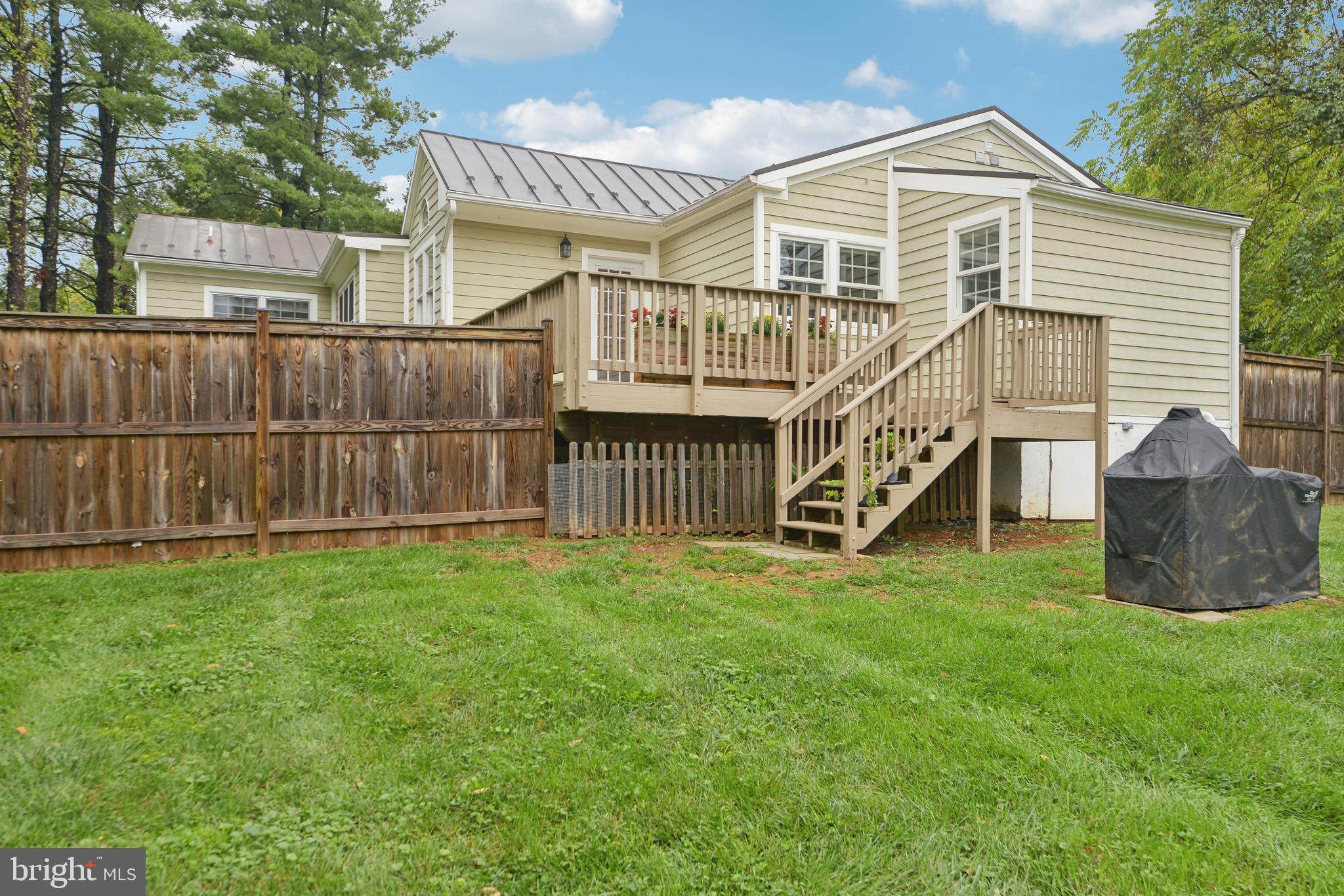 39913 Thomas Mill Road Leesburg, VA 20175 - Photo 38 of 46 a view of a house with a yard and a wooden deck