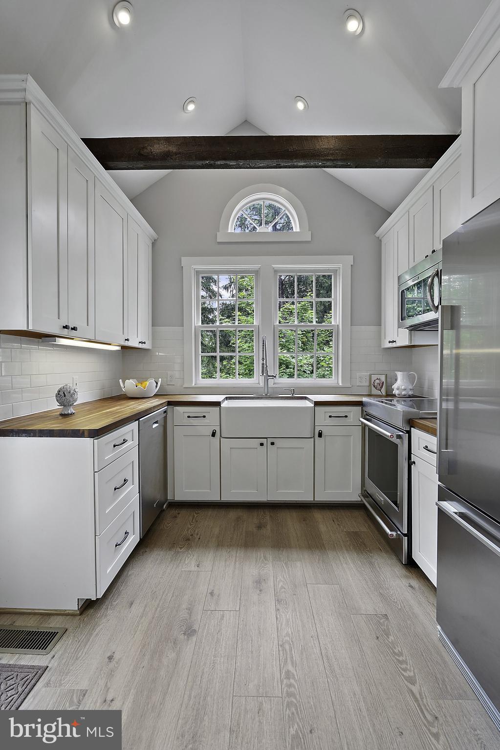 39913 Thomas Mill Road Leesburg, VA 20175 - Photo 6 of 46 a kitchen with a white cabinets and wooden floor