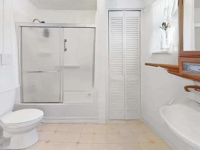 a bathroom with a toilet and a shower